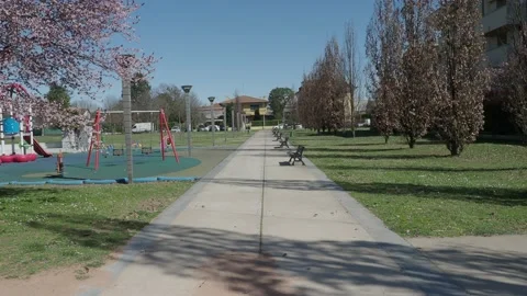 Long row of empty benches at public park closed for lockdown Stock Footage 150439982