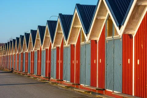 Long row of small, red storage houses with blue doors. Stock Photos