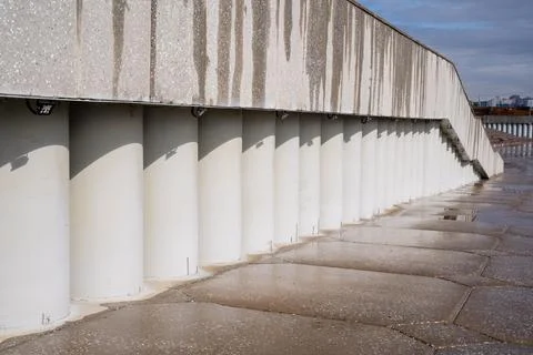 A long row of solid concrete columns stands proudly lined up right next to .. Fotos de archivo