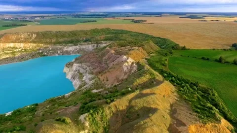 Long sandy beach and rocky coastline meet turquoise ocean Video stock 333875114