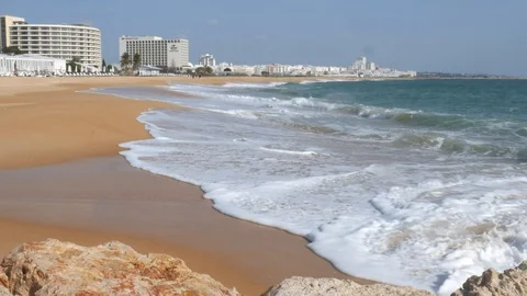 Long sandy beach in Vilamoura, Loule, Algarve, Portugal on a sunny day Stock Footage 103290124