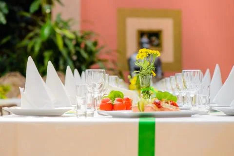 Long served table with dishes Фото