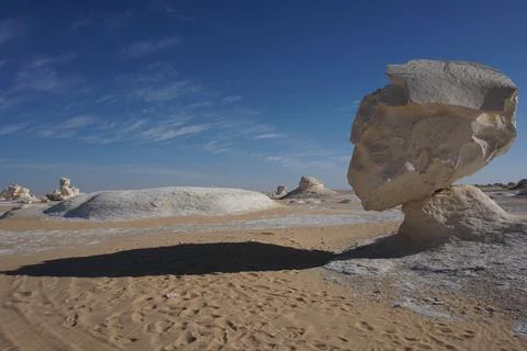 Long shadow of a head shaped rock formation in the white desert Stock Photos
