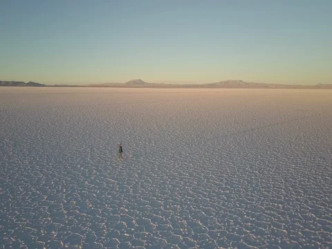 Long shadow of person walking on the Salar de Uyuni in Bolivia at sunset Stock Footage 83291644