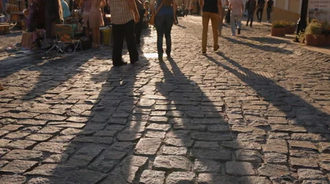 Long shadow of walking in sunset light people Stock Footage 56728924