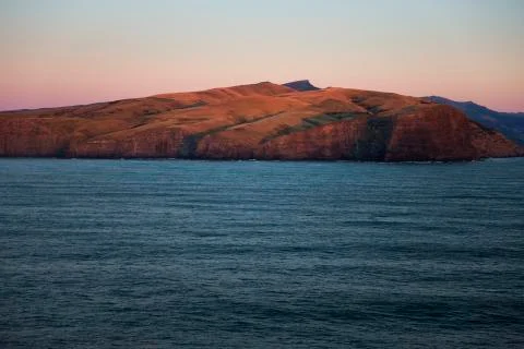 Long shadows over the red colored hills. Stock Photos