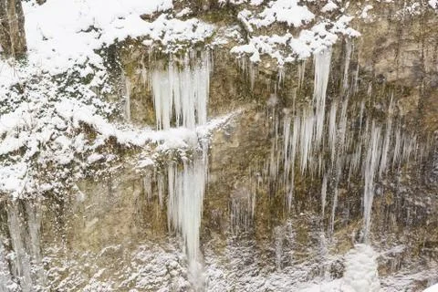 Long, sharp icicles on the snow covered steep slopes of the canyon - the gorg Stock Photos