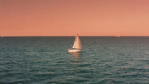 Long shot aerial side view of an isolated sailboat at sea. Stock Footage 201157743
