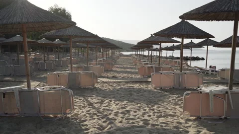Long shot of beach with deck-chairs and umbrellas. Seaside resort. Summer Stock Footage 147948076