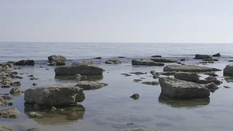 Long shot of a beach in Sicily, sea, rocks and good light.  Stock Footage