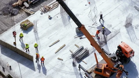 Long shot: builders making concrete slab under crane at the construction site Stock Footage 236473893