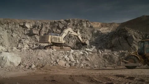 Long shot of construction vehicles working on a construction site Stock Footage 312400428