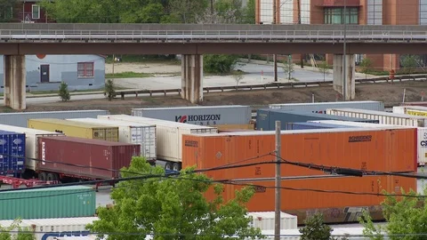 Long shot of CSX train yard in Atlanta, Georgia as MARTA subway train passes Video stock 74489966