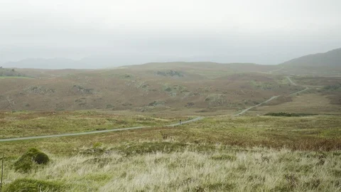 Long Shot of Cyclist Cycling Down Hill in Countryside 4K Stock Footage 89940855