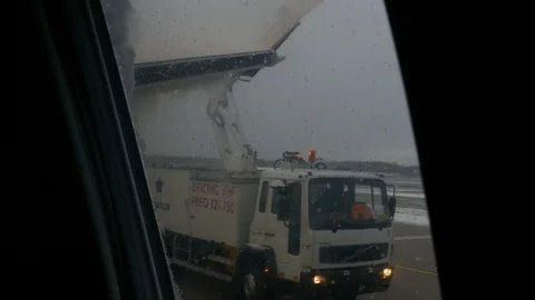 Long shot of de icing the airplane during winter to prepare for flight departure Stock Footage 88880205