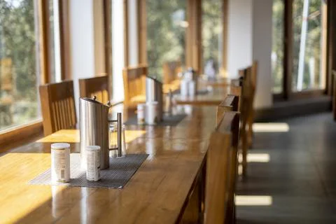 Long shot of a dining table with glasses, fork, jugs on the top of the table. 写真素材