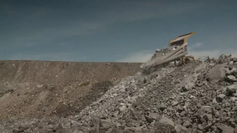 Long shot of a dump truck dumping its load Stock Footage 312400450