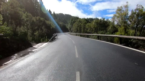 Long shot of an empty road into the middle of the mountains Stock Footage 197624293