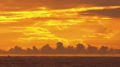 Long shot of epic golden sunset sky with a lonely fisherman boat far away Stock Footage 151692458