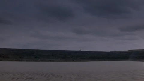 Long shot of an explosion next to a lake Stock Footage 312274145
