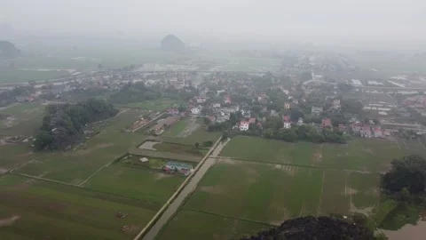 Long Shot of Fields and Village Hazy Stock Footage 255029342
