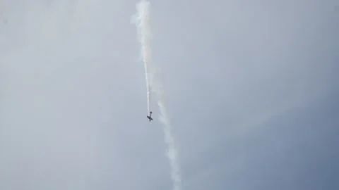 Long shot of flying down small-seat plane in patrially cloudy sky when summer Stock Footage 220494137