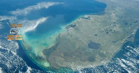Long shot: flying parallel to the ISS, over the Florida peninsula Video stock 120148684