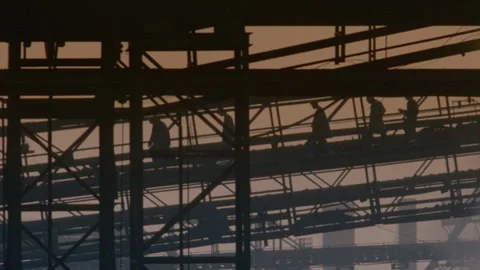 Long shot of a group of silhouetted construction workers Stock Footage 312273098