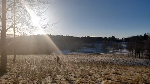 Long Shot of Guy Running Happliy a Snowy Winter Day Stock Footage 99532583