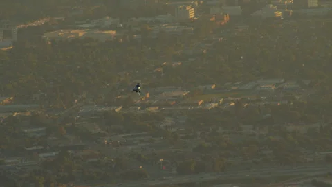 A long shot of a helicopter hovering over the city of Los Angeles Stock Footage 282001701