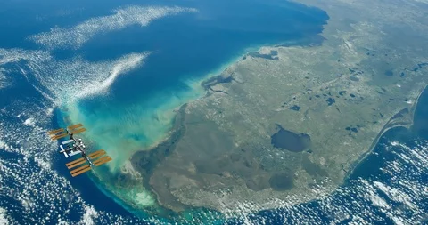 Long shot: ISS flying into the distance, over the Florida peninsula Stock-Footage 120148851
