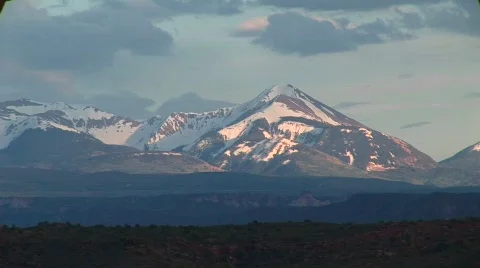 Long shot of the La Sal Mountains at golden-hour Stock Footage