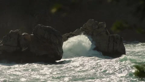 Long shot of large rocks battered by rough seas on Mediterranean island Video stock 168801883