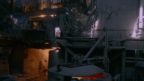 Long shot of machines at work inside a steel mill/plant Stock Footage 312274064