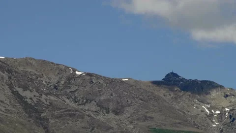 Long shot mountain tip in summer covered by a passing cloud. Stock Footage 154943220