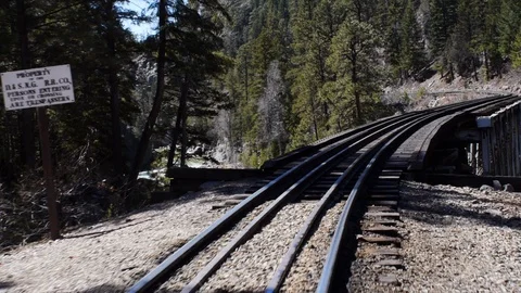 Long shot of a moving passenger train on a curve railroad track Stock Footage 90023503