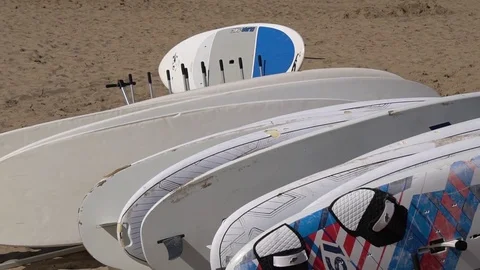 LONG SHOT OF PADDLE BOARDS STACKED IN A STORAGE ROW Stock Footage 79363149