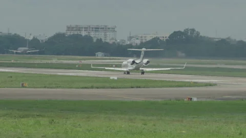 Long Shot pan-left An airplane takes off from an airport Stock Footage 203069663