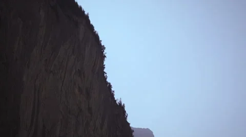 Long shot of paraglider falling off mountain Stock Footage 52229546