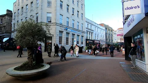 Long shot of people walking through the center of Bournemouth, UK Video stock 200886174