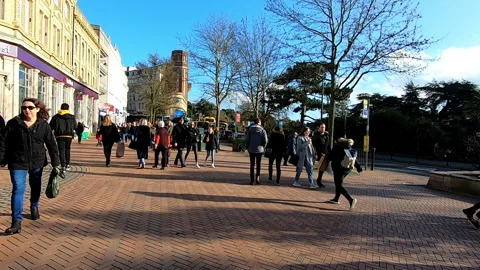 Long shot of people walking through Bournemouth town center, sunny day Video stock 200886995