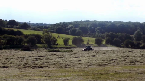 Long shot red Tractor moves through picturesque rural European Landscape Stock Footage 39540966