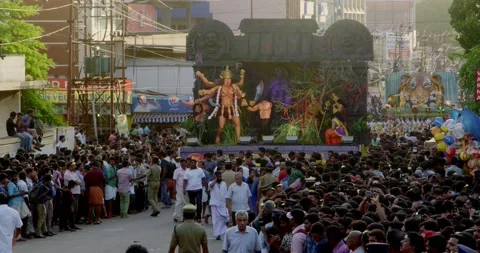 Long shot of a religious tableau moving slowly through a crowd of Stock Footage 170526899