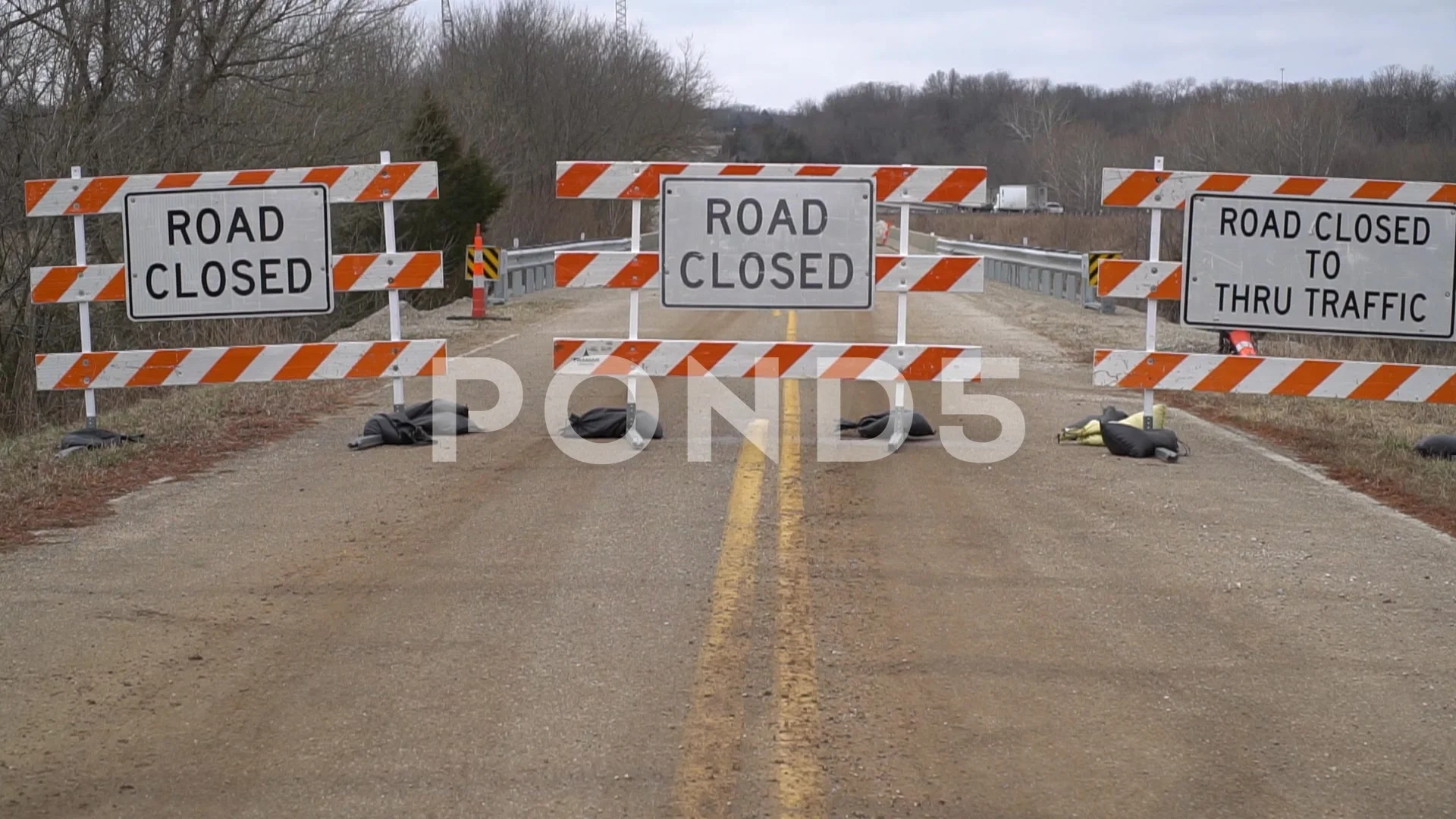 A long shot of road signs reading Road Closed