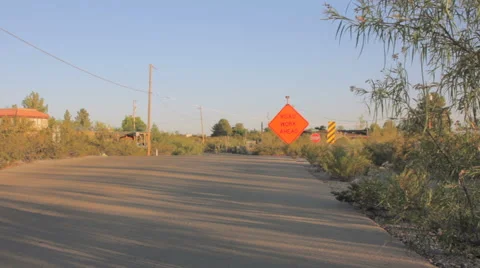 Long Shot of a Road Work Sign on a Residential Road Stock Footage 64330698