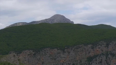 Long shot of a rocky mountain Stock Footage 77717623