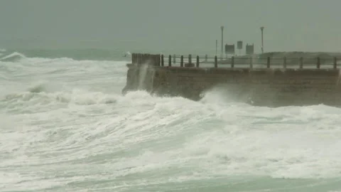 Long shot of rough waves breaking on walls Stock Footage 310385720