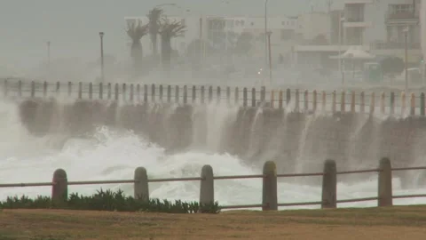 Long shot of rough waves breaking on walls Stock Footage 310385737