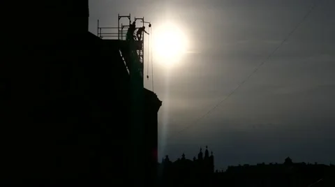 Long shot silhouette construction workers building house using crane scaffolding Stock Footage 67895772
