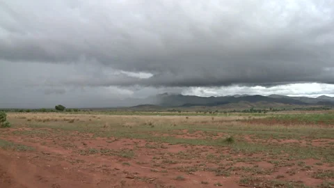 Long shot of a storm brewing over a large piece of land Stock Footage 310540684